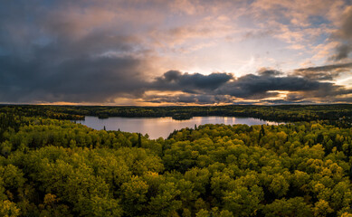 an aerial view of forest lake and surrounding area in autumn, located in northwest, ontario, canada