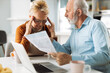 © Goran - Frustrated senior couple arguing about their home finances at home