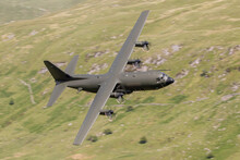 Royal Air Force (RAF) C130 Hercules Four Engined Transporter Flying Low Level