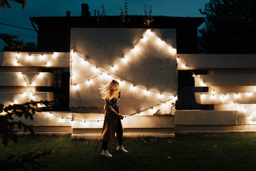 girl walks in the evening city, night city lights, city photo