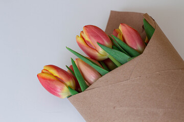 Bouquet of red and orange tulips in paper. Spring flowers.