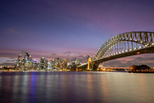 Beautiful Sunset Colours Over Iconic The Sydney Harbour Bridge And Skyline.