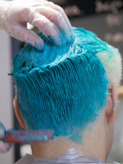 the process of coloring and coloring hair in the color of the sea wave