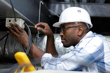 electrician installer working on the ceiling