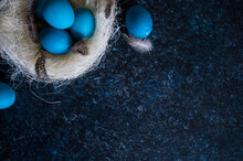Blue Easter Eggs With Twigs In A Decorative Nest