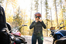 Woman In Helmet Preparing To Ride Motorbike
