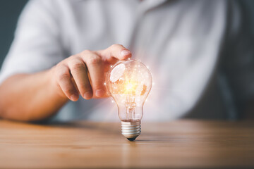 Poster - Businessman touching a bright light bulb. Concept of Ideas for presenting new ideas Great inspiration and innovation new beginning.