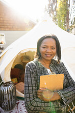 Portrait Of Wedding Planner With Clipboard Near Yurt