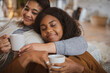 © Tom Merton/Caia Image - Affectionate mother and daughter cuddling with tea