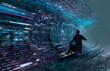 © Rana Dias/Caia Image - Businessman surfing binary code wave