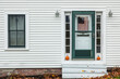 USA, Maine, Wiscasset. House detail with US flag during autumn.