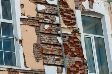 Wall Mural - Close-up. The facade of the historic building is collapsing. Collapsing walls of an architectural monument.