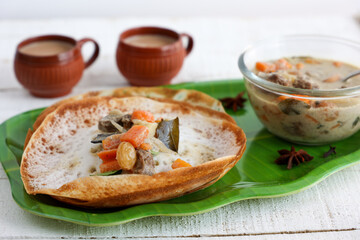 Wall Mural - Appam, Hoppers and mutton stew Kerala breakfast food and Indian milk tea chai, christian breakfast India Sri Lanka Tamil Nadu fermented rice pan cake. Indian veg food.