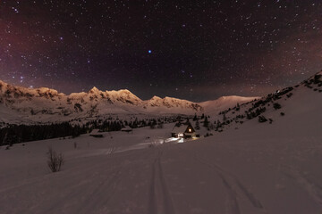 Wall Mural - night winter landscapes in the high tatras, with mountain houses on a background of snow-capped moun