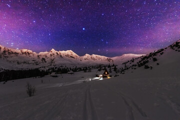 Wall Mural - night winter landscapes in the high tatras, with mountain houses on a background of snow-capped moun