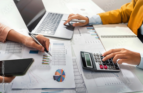 Fototapeta na szkło close up hand accountant holding pen pointing on paperwork chart for meeting team in office room. concept finance and accounting