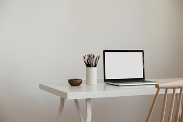 Wall Mural - Blank screen laptop computer. Home office desk table workspace. Modern minimal Scandinavian interior design. Blog, magazine, web, social media template with copy space mockup.