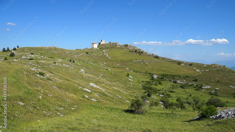 Apennine Mountains grassy landscape with castle on the hil, Gran Sasso ...