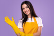 Cheerful housewife putting on rubber gloves