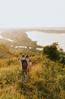 © Natalia - joyful girl and man walk at sunset walk across the field