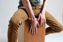 Hands Playing Cajon On A White Background.
