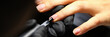 Gloved technician applies transparent gel polish to client's nails. Manicure training concept