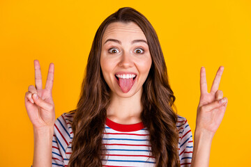 Poster - Close-up portrait of attractive cheerful funky girl showing double v-sign grimacing having fun isolated over bright yellow color background