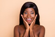 © deagreez - Photo of sweet impressed dark skin naked lady hands arms cheekbones cheeks isolated beige color background