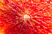 Bloody Red Sicilian Orange Pulp Texture Background. Macro Photo Of Red Orange Fruit. Citrus Friut Close Up