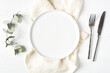 © Anna - An empty plate and cutlery on a white wooden table. Top view.