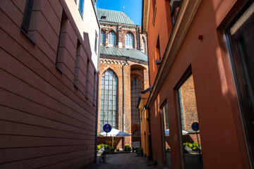 Wall Mural - narrow street to big cathedral in old town in Europe 