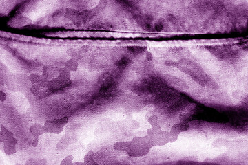 Old camouflage cloth with blur effect in purple tone.