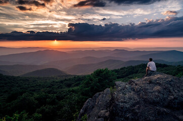 Wall Mural - A hiker enjoying a Summer sunset from Bearfence Mountain in Shenandoah National Park.