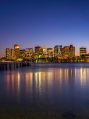Wall Mural - Boston Nightscape Skyline and Weathered Pier with Damaged Pilings. Harmony of Nature, Civilization, and Reflections of Lights and Time.