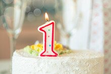 Birthday Candle As Number One  On Top Of Sweet Cake On The Table, Concept Picture
