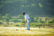 © freebird7977 - Golfer sport course golf ball fairway. People lifestyle man approach playing game golf tee off on the green grass.  Asian man player game shot in summer.