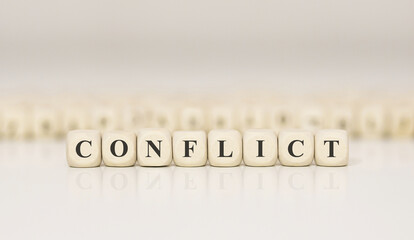 Wall Mural - Word CONFLICT made with wood building blocks