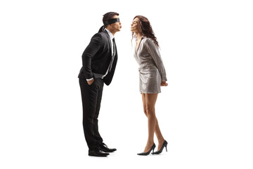 Sticker - Full length profile shot of a man in a suit with blindfold kissing a woman in a dress