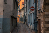 Fototapeta Uliczki - A narrow street with old houses in Riga. Old Town historic district. 