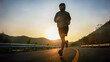 © pixfly - Full length of male runner training outdoors exercising on asphalt road at sunrise . Fit handsome athlete jogger working out for marathon run outside in summer