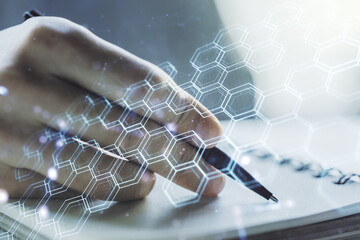 Poster - Creative abstract technology sketch with hexagon grid and man hand writing in notepad on background, future technology and AI concept. Double exposure