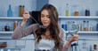 © LIGHTFIELD STUDIOS - woman in apron holding lid and ladle while smelling soup