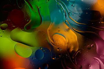 Wall Mural - bright colorful oily drops in water with colorful background, close-up 