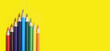 pencils on yellow background with copy space. School and creative painting concept with colored pencils. Back to school banner.
