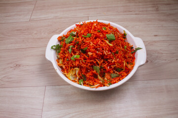 Wall Mural - Schezwan fried rice with Schazwan sauce, Chinese fried rice, garnished with spring onions and cabbage. Indian-Chinese dishes; selective focus