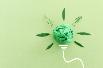 Wall Mural - Concept image if green crumpled paper lightbulb, symbol of scr, innovation and eco friendly business