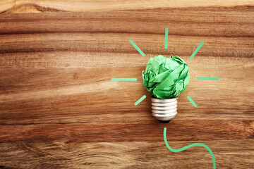 Wall Mural - Concept image if green crumpled paper lightbulb, symbol of scr, innovation and eco friendly business