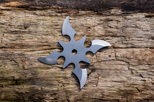 Shuriken (throwing Star), Traditional Japanese Ninja Cold Weapon Stuck In Wooden Background