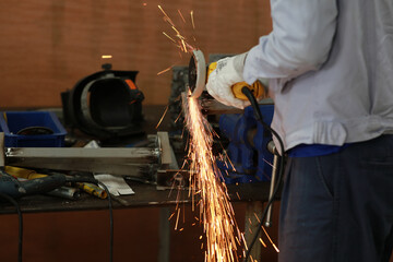 Technician but and grinding metal in maintenance workshop, Industrial concept