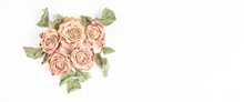 Long Festive Banner With Place For Text. Beautiful Composition Of Dry Roses On A White Background. Minimalistic Simple Flat Lay